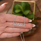 Woman holding custom name necklace designed to celebrate meaningful connections, this one is in silver (stainless steel).