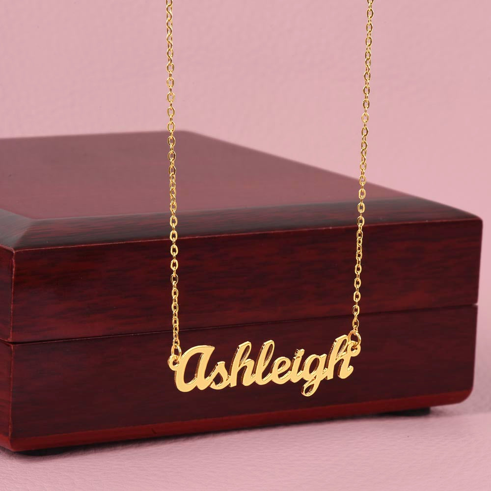 Custom name necklace designed to celebrate meaningful connections, the name is ASHLEY and it is shown with a luxury gift box.