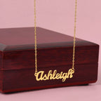Custom name necklace designed to celebrate meaningful connections, the name is ASHLEY and it is shown with a luxury gift box.
