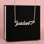 Name necklace in the color silver hanging from a black gift box from I Got You A Gift.