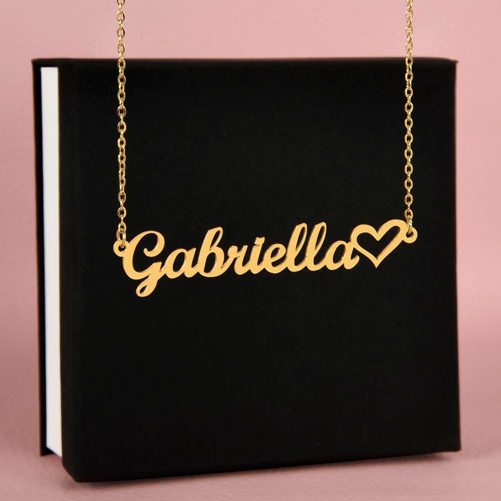 Name necklace in the color gold hanging from a black gift box from I Got You A Gift.