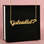 Name necklace in the color gold hanging from a black gift box from I Got You A Gift.