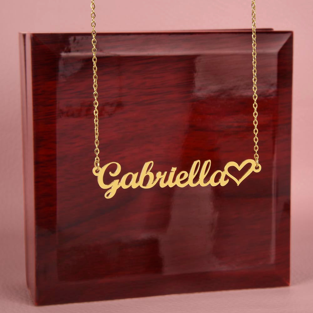 Name necklace in the color gold hanging from a luxury gift box from I Got You A Gift.