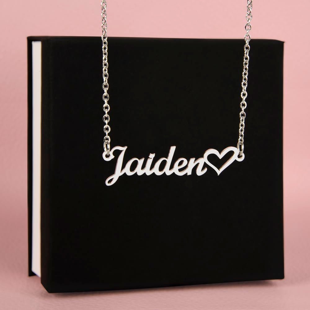 Name necklace in the color silver hanging from a black gift box from I Got You A Gift.