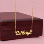Custom name necklace designed to celebrate meaningful connections, the name is ASHLEY and it is shown with a luxury gift box.