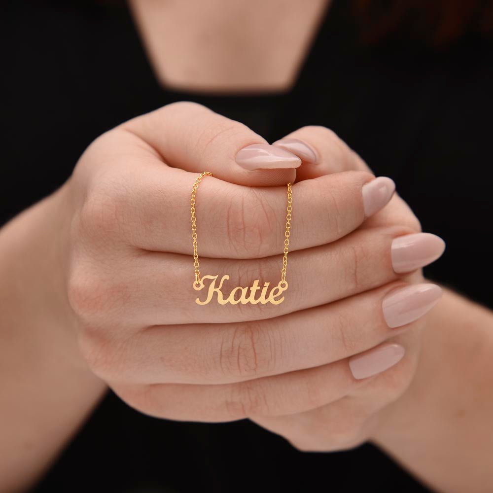 Woman holding custom name necklace designed to celebrate meaningful connections, the name on this one is KATIE.