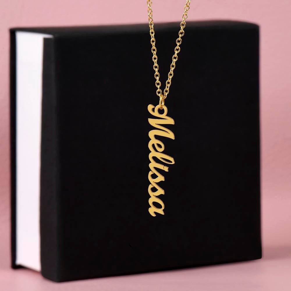Custom name necklace designed to celebrate meaningful connections hanging on a black gift box. The color of it is gold.