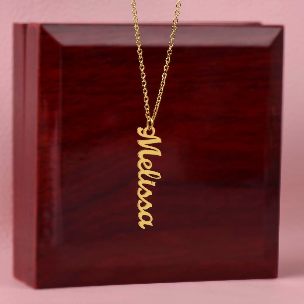 Custom name necklace hangind on display on a luxury gift box, the color is gold. The name on the necklace is Melissa.