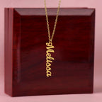 Custom name necklace hangind on display on a luxury gift box, the color is gold. The name on the necklace is Melissa.