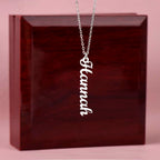 Custom name necklace hangind on display on a luxury gift box, the color is silver. The name on the necklace is Hannah.